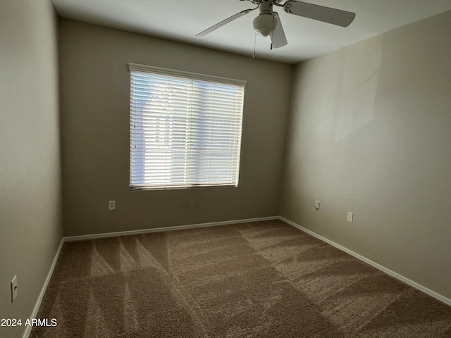 carpeted empty room featuring ceiling fan