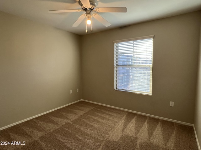 carpeted empty room featuring ceiling fan