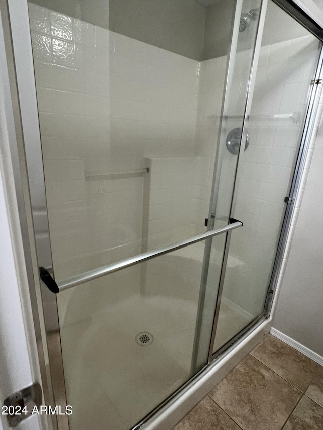 bathroom featuring tile patterned floors and an enclosed shower