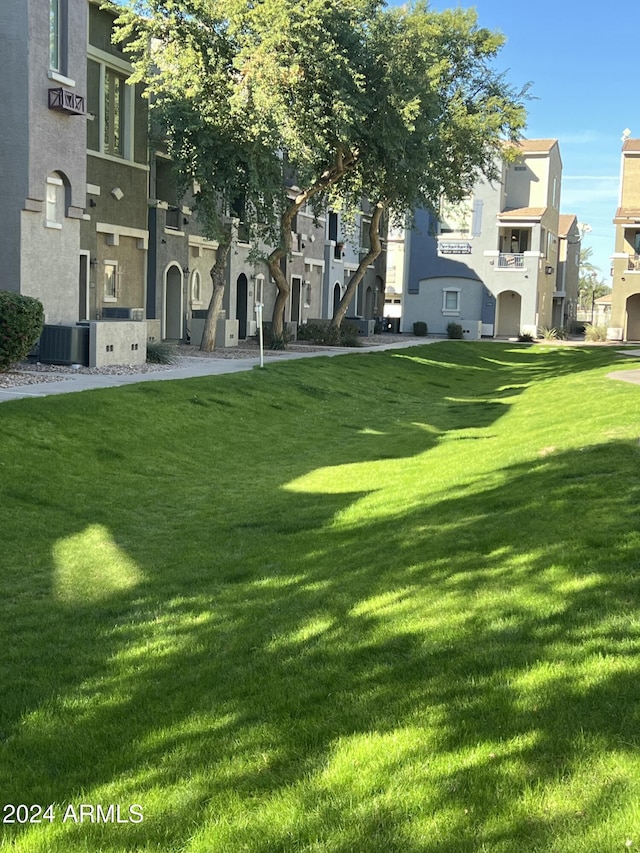 view of property's community with a lawn