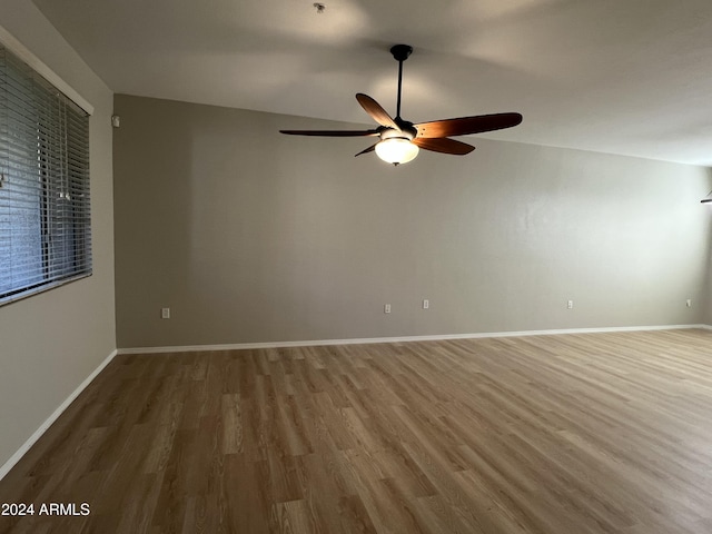 unfurnished room with hardwood / wood-style floors and ceiling fan