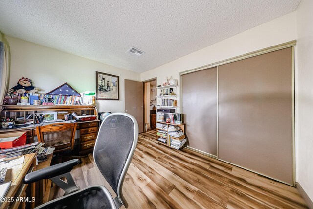 office area featuring wood finished floors and a textured ceiling