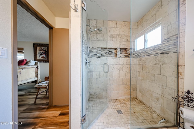 bathroom featuring a stall shower and wood finished floors