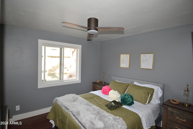 bedroom with dark hardwood / wood-style floors and ceiling fan