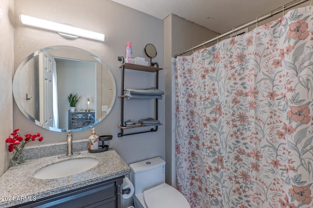 bathroom with vanity, a shower with shower curtain, and toilet