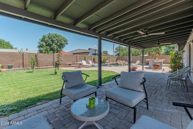 view of patio with a fenced in pool and ceiling fan