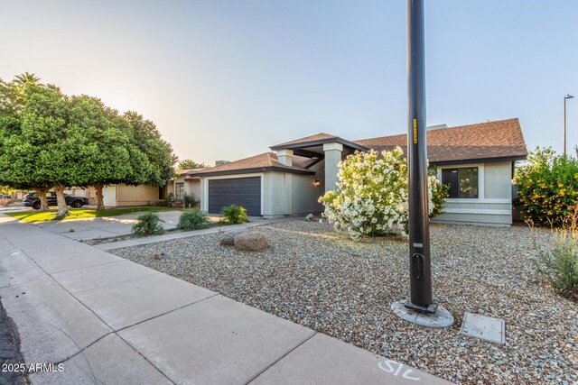 756 E Appaloosa Rd, Gilbert, AZ 85296 - view of front of house featuring a garage, concrete driveway, stucco siding, and roof with shingles