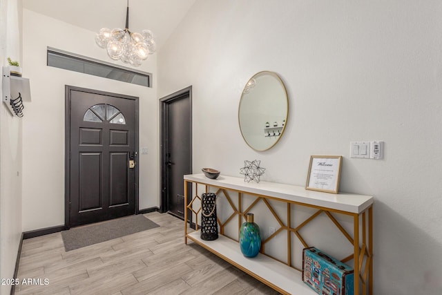 756 E Appaloosa Rd, Gilbert, AZ 85296 - foyer with a chandelier, light wood finished floors, vaulted ceiling, and baseboards