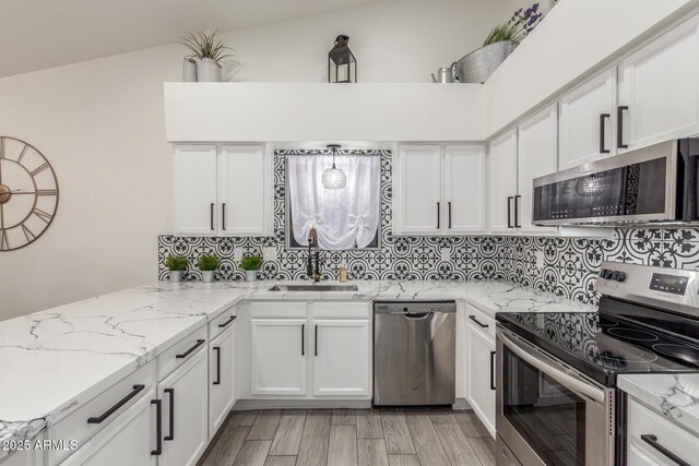 756 E Appaloosa Rd, Gilbert, AZ 85296 - kitchen with stainless steel appliances, a sink, white cabinetry, and decorative backsplash