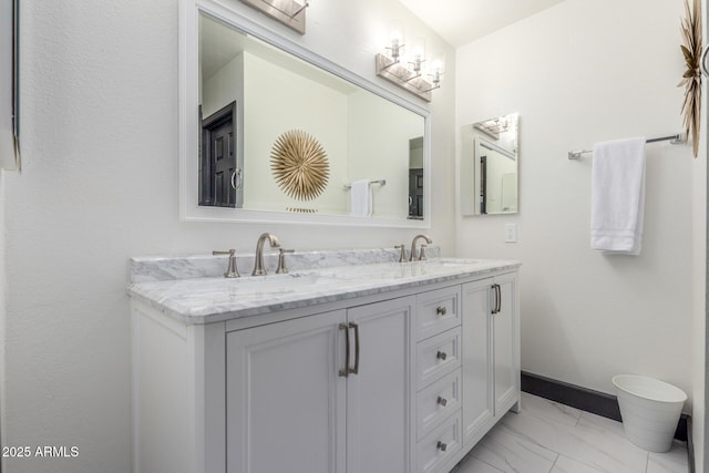 756 E Appaloosa Rd, Gilbert, AZ 85296 - bathroom featuring marble look tile flooring, double vanity, and baseboards
