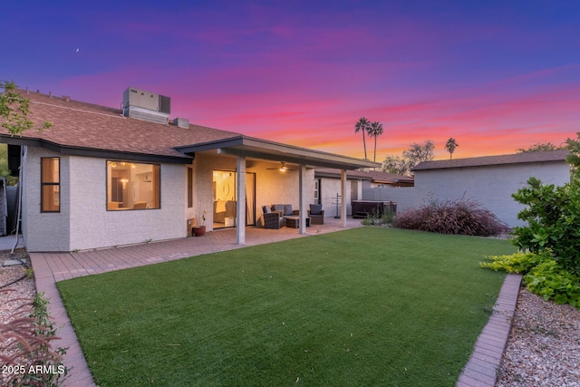 756 E Appaloosa Rd, Gilbert, AZ 85296 - rear view of house featuring ceiling fan, a lawn, a patio, an outdoor living space, and stucco siding