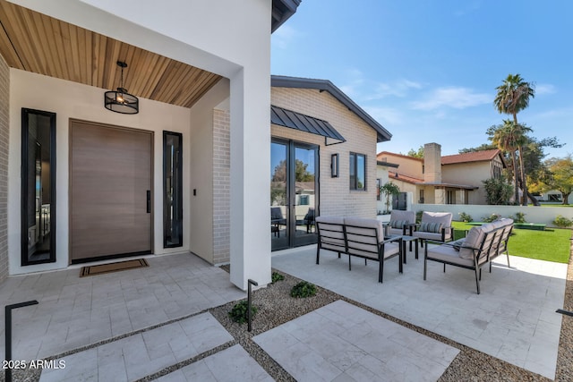 entrance to property with an outdoor hangout area and a patio area