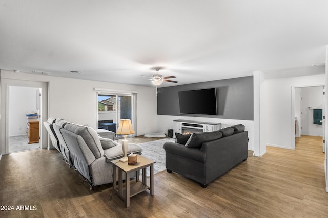 530 W Pintail Dr, Casa Grande, AZ 85122 - living area featuring ceiling fan, wood finished floors, and a lit fireplace