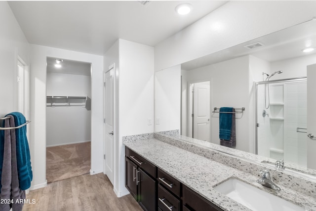 530 W Pintail Dr, Casa Grande, AZ 85122 - full bathroom featuring wood finished floors, vanity, a shower stall, and a spacious closet