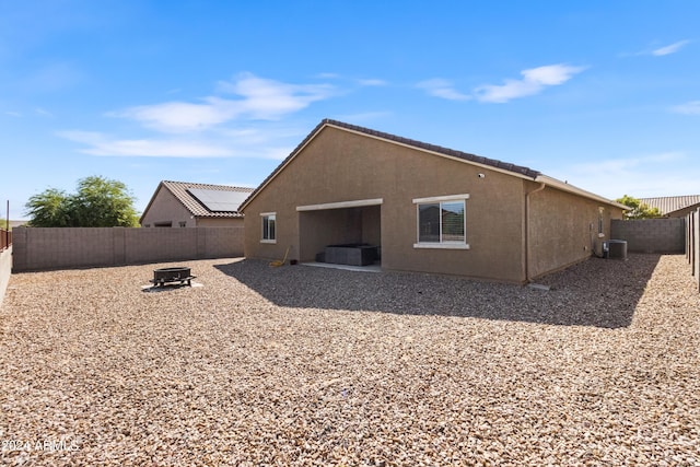 530 W Pintail Dr, Casa Grande, AZ 85122 - rear view of property featuring a fenced backyard, an outdoor fire pit, stucco siding, and a patio