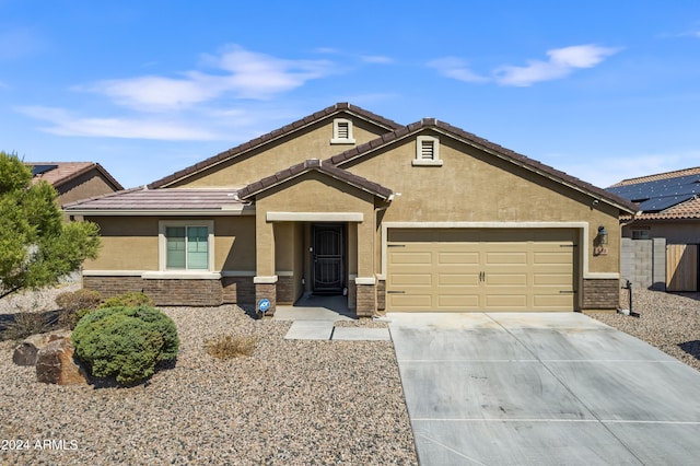 530 W Pintail Dr, Casa Grande, AZ 85122 - view of front of property with stucco siding, driveway, a garage, stone siding, and a tiled roof