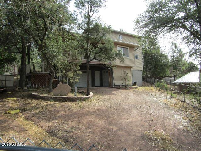 2007 N Murchison Cir, Payson, AZ 85541 - rear view of house featuring driveway and a garage