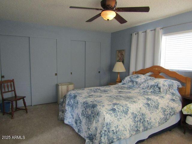2007 N Murchison Cir, Payson, AZ 85541 - carpeted bedroom with multiple closets, ceiling fan, and a textured ceiling
