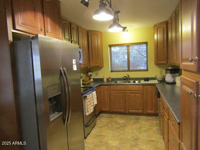 2007 N Murchison Cir, Payson, AZ 85541 - kitchen featuring appliances with stainless steel finishes, dark countertops, a sink, and brown cabinetry
