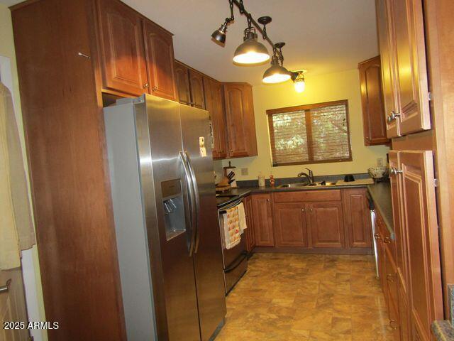 2007 N Murchison Cir, Payson, AZ 85541 - kitchen featuring range with electric cooktop, stainless steel fridge with ice dispenser, a sink, dark countertops, and brown cabinets