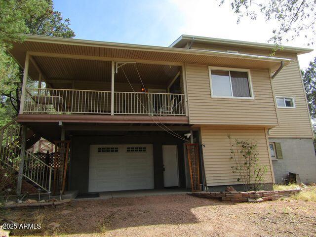 2007 N Murchison Cir, Payson, AZ 85541 - view of front facade with a garage, dirt driveway, and a balcony