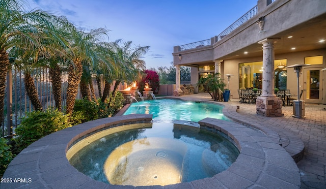 4332 N Santiago Cir, Mesa, AZ 85215 - pool at dusk featuring a patio area, a pool with connected hot tub, and fence