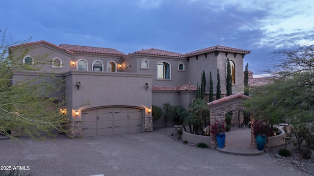 4332 N Santiago Cir, Mesa, AZ 85215 - mediterranean / spanish-style house featuring a tiled roof, stucco siding, stone siding, and decorative driveway