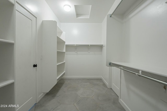 spacious closet featuring light tile patterned floors