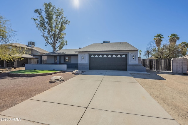 single story home featuring driveway, brick siding, an attached garage, and cooling unit