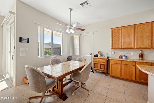dining room featuring visible vents, ceiling fan, and light tile patterned floors