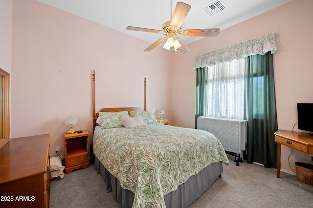 bedroom with ceiling fan, light colored carpet, radiator heating unit, and visible vents