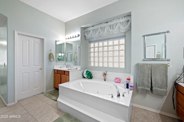 bathroom featuring a jetted tub, vanity, tile patterned flooring, and baseboards