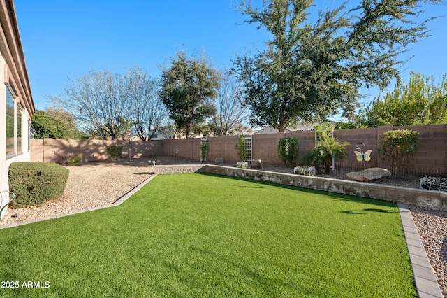 view of yard with a fenced backyard