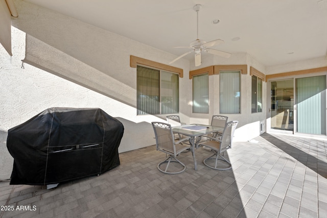view of patio / terrace with grilling area, a ceiling fan, and outdoor dining area
