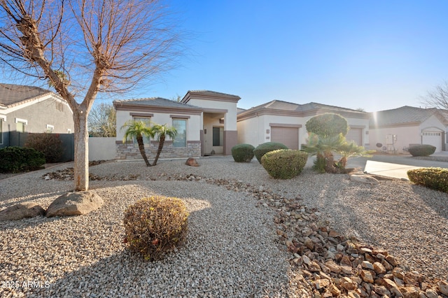 view of front of home featuring fence, an attached garage, stucco siding, concrete driveway, and a tiled roof