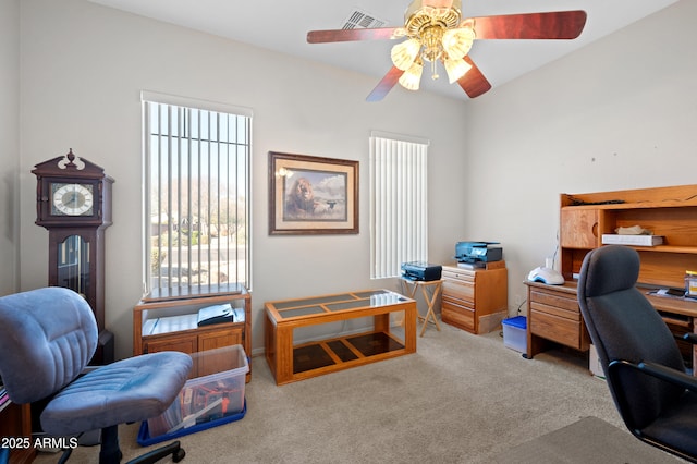 office featuring carpet flooring, a ceiling fan, and visible vents