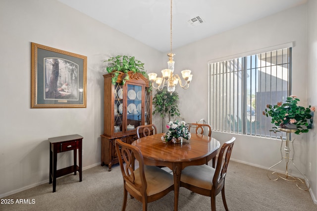 carpeted dining area featuring visible vents, baseboards, and a chandelier