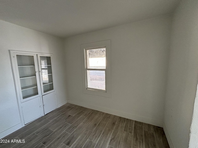 empty room featuring dark wood-type flooring