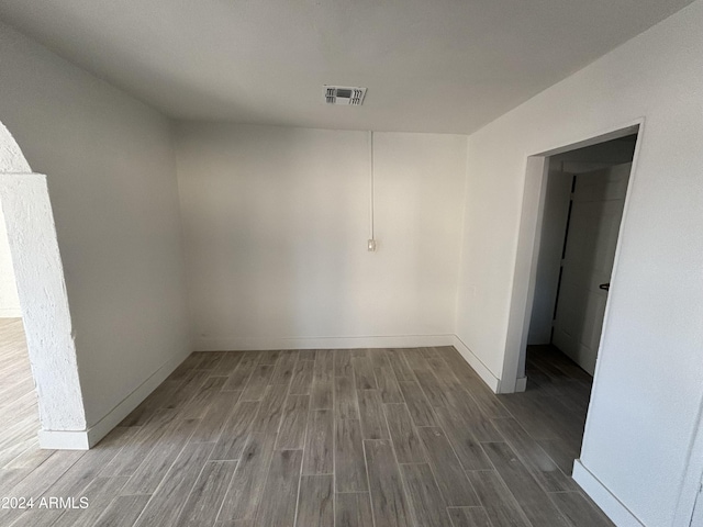 spare room featuring wood-type flooring