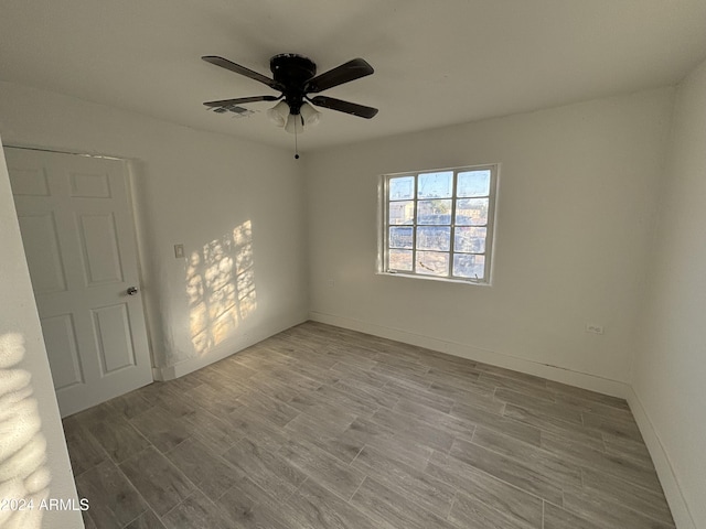 empty room with light wood-type flooring and ceiling fan