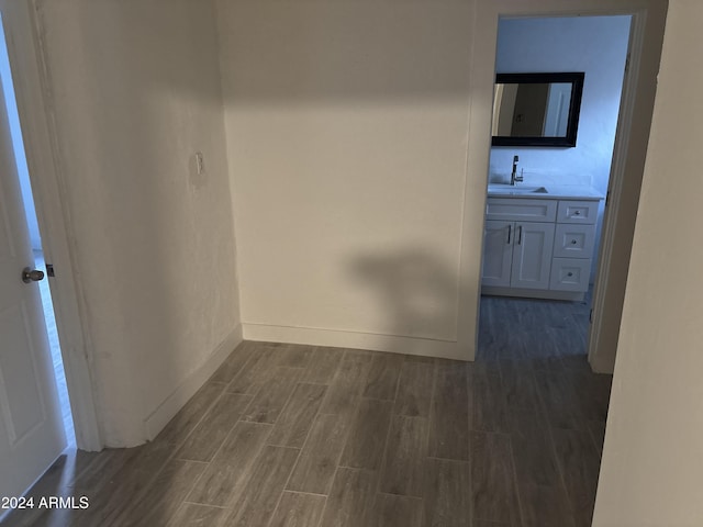 hall with dark hardwood / wood-style floors and sink