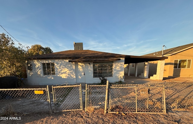 rear view of house featuring a carport