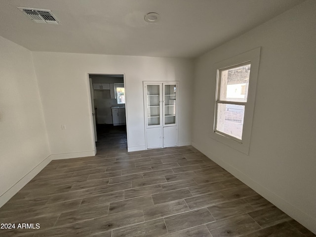 unfurnished room featuring dark wood-type flooring