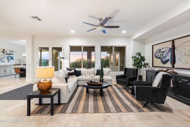 living area featuring visible vents, stone tile flooring, and recessed lighting