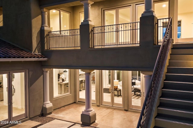 back of property with french doors, stairway, a patio area, and stucco siding