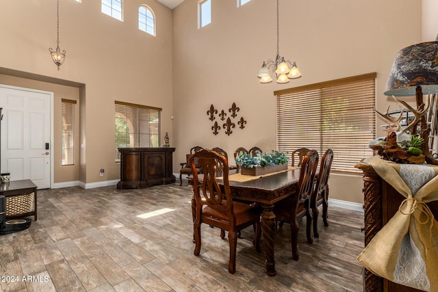 6084 W Yorktown Way, Florence, AZ 85132 - dining space featuring baseboards, a towering ceiling, and a chandelier
