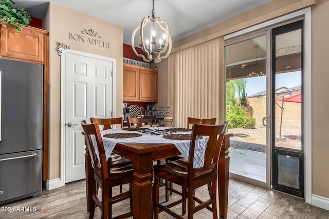 6084 W Yorktown Way, Florence, AZ 85132 - dining room featuring baseboards, light wood-type flooring, and a chandelier