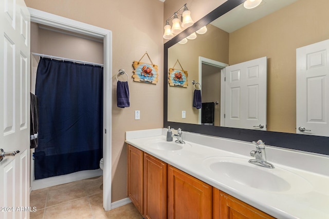 6084 W Yorktown Way, Florence, AZ 85132 - bathroom featuring double vanity, a sink, tile patterned flooring, and toilet