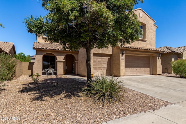 6084 W Yorktown Way, Florence, AZ 85132 - mediterranean / spanish-style home featuring stucco siding, a tile roof, and concrete driveway
