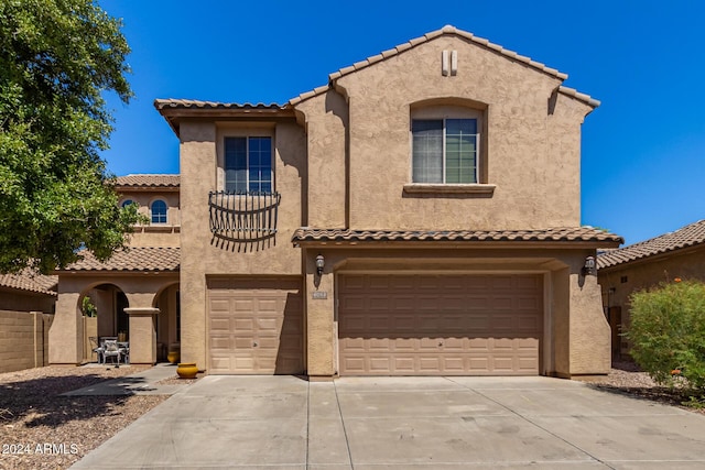 6084 W Yorktown Way, Florence, AZ 85132 - mediterranean / spanish-style home featuring an attached garage, stucco siding, a tile roof, and concrete driveway